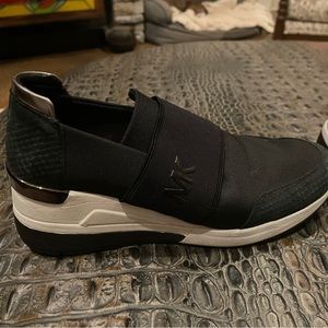 Lightly used Michael Kors black slip on shoes, size 8